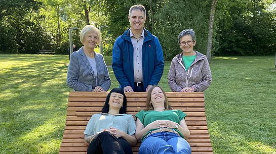 Himmelsliege (gewellte Holzliege) und fünf Personen, die diese einweihen